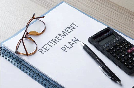 Retirement plan concept with notebook, glasses, and calculator - financial planning essentials